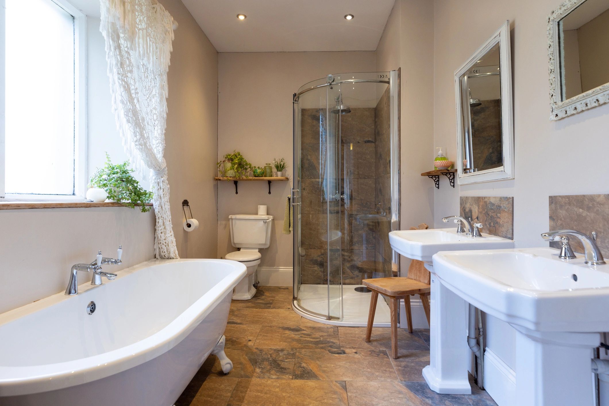 Neutral bathroom with tub, shower, and double sinks
