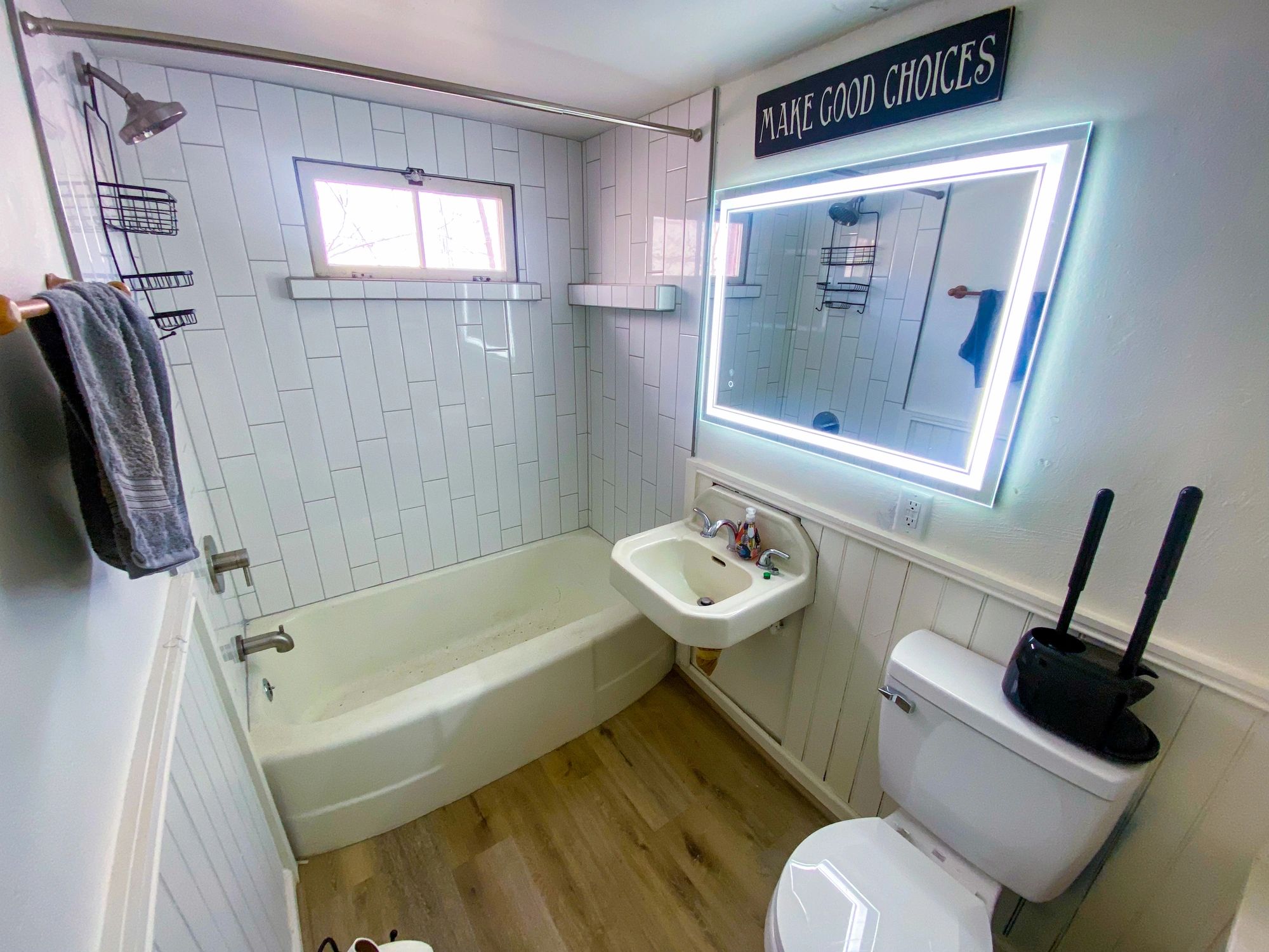 Bathroom with tub-shower and white tile surround